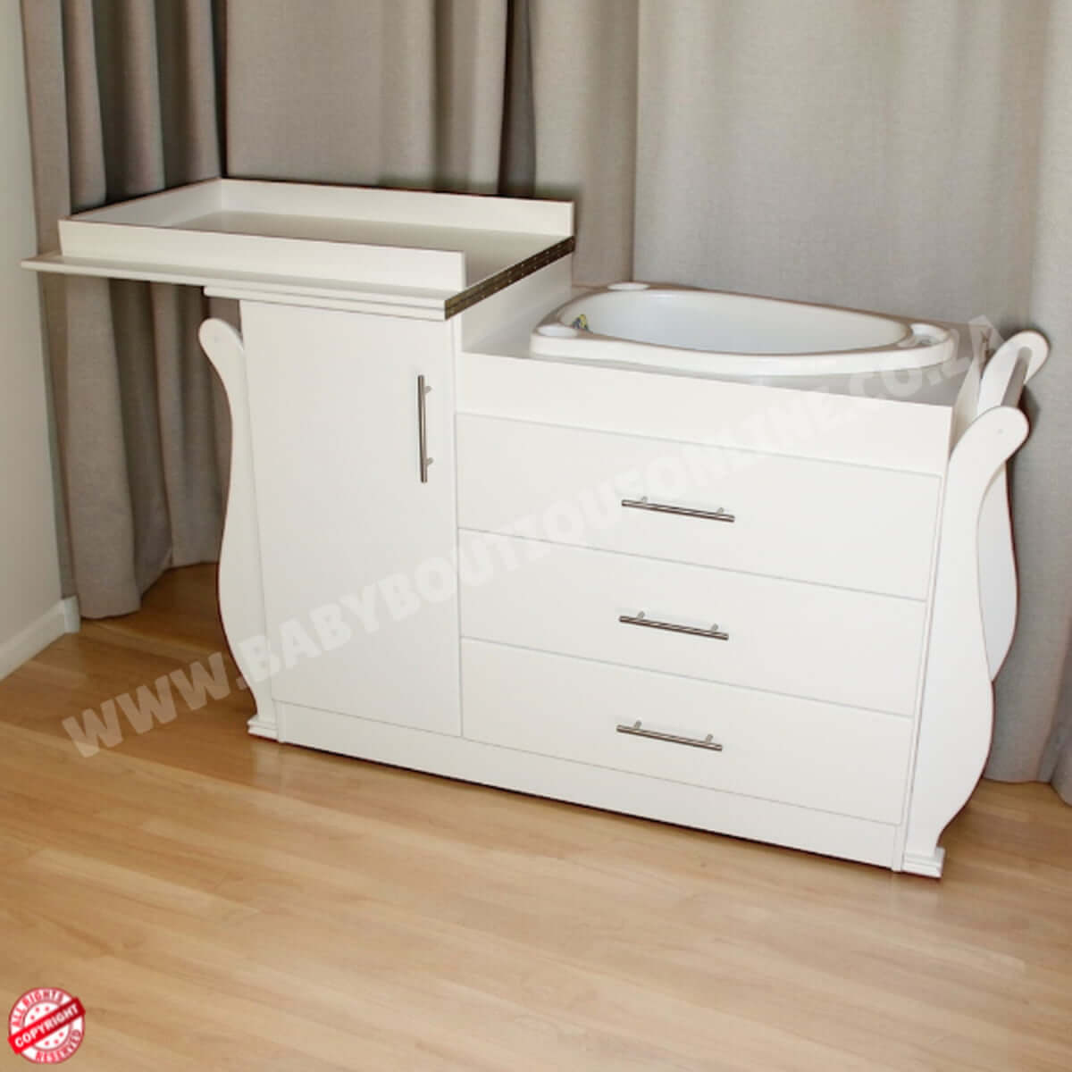 White baby changing table with drawers against a gray curtain background