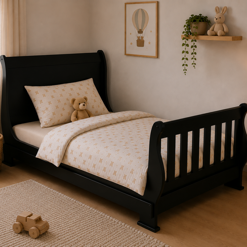 A black wooden children's bed with a tall wingback headboard and slatted footboard, dressed in cream bedding with a small teddy bear on the pillow, shown in a styled nursery room.