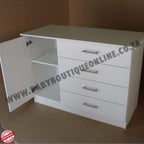 White dresser with open door on a brown background