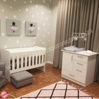 Nursery room with Large Wooden Cot-white crib, changing table, and decorative elements.