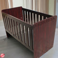Large Wooden Cot- Burgundy crib with a visible brand logo on a light background