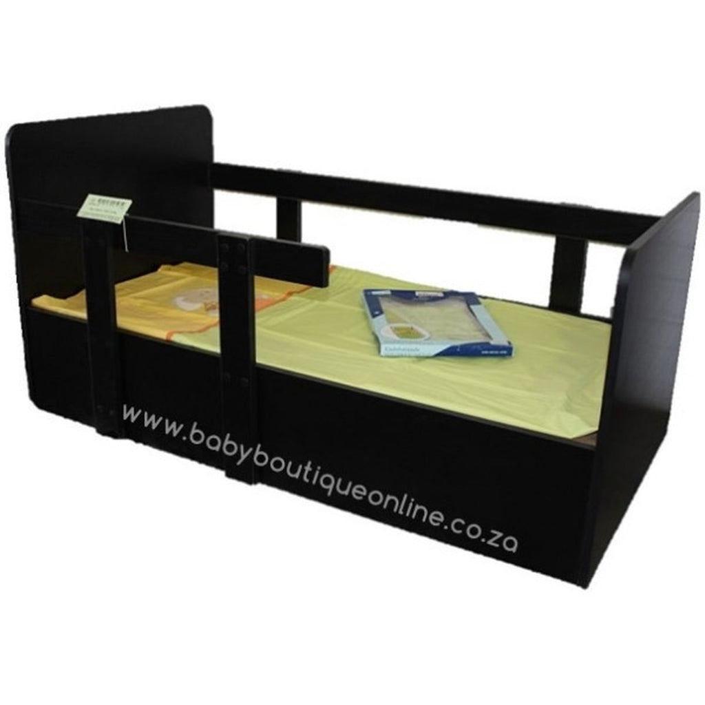 Black toddler bed with green mattress and folded blanket on a white background