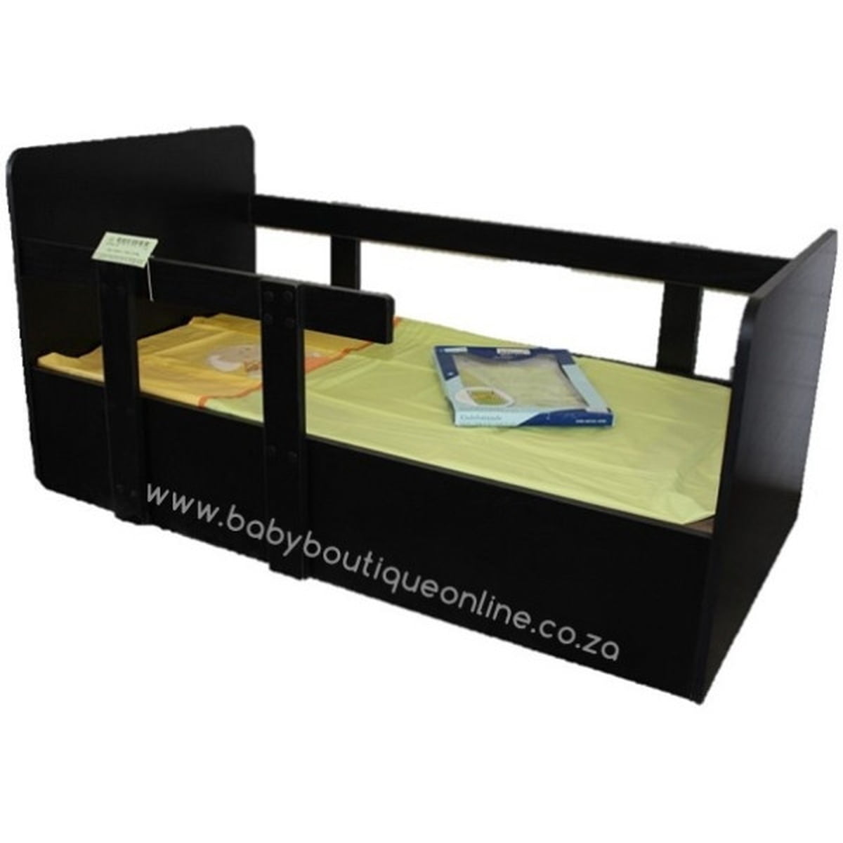 Black toddler bed with green mattress and folded blanket on a white background
