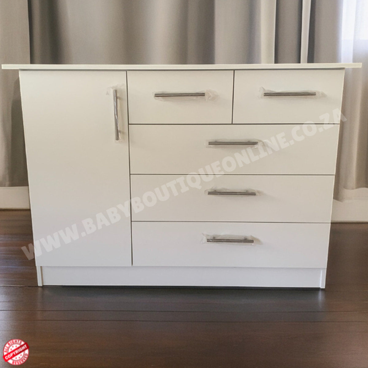 White dresser with multiple drawers against a neutral background