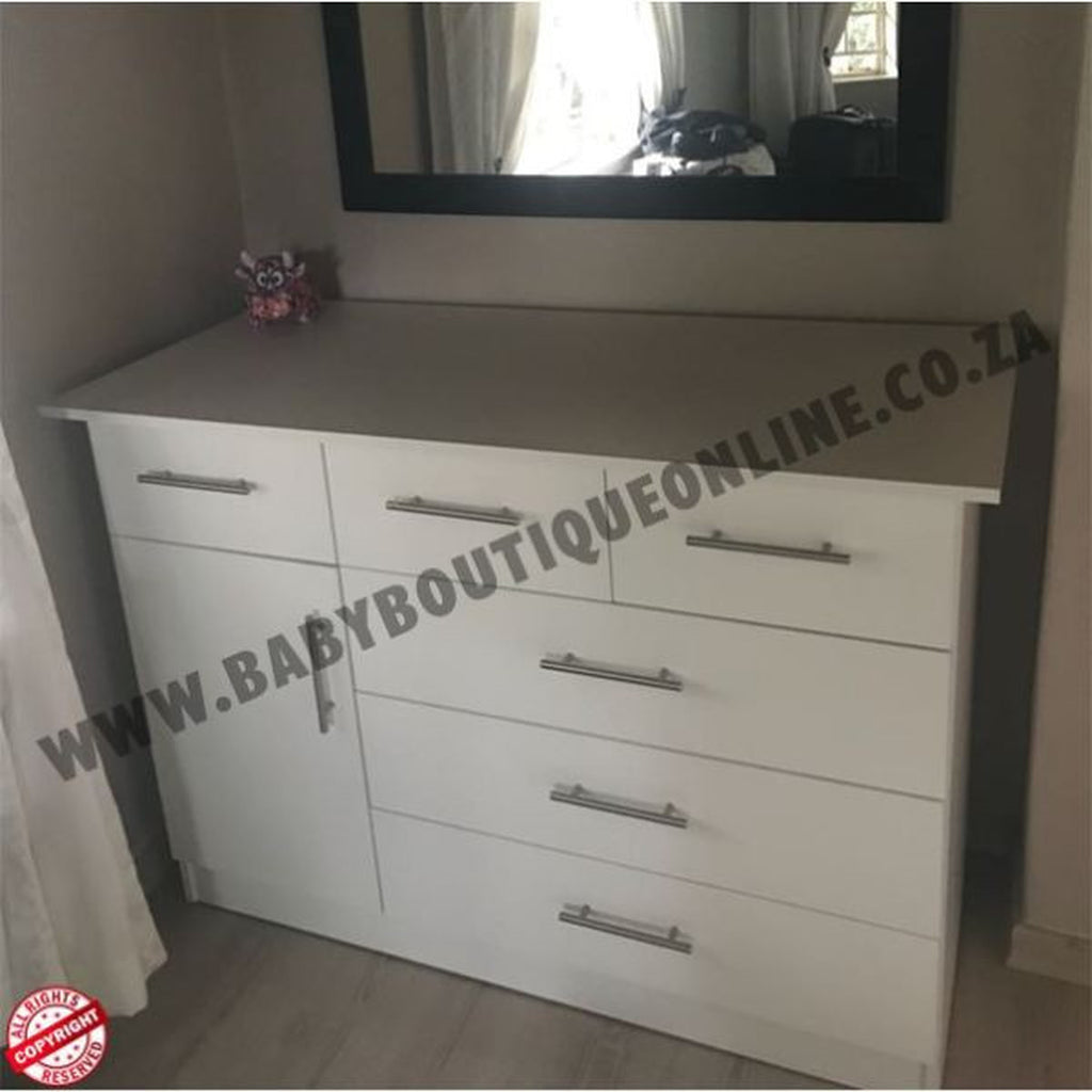 White dresser with multiple drawers and a mirror above it in a room setting.Large Compactum - 3 Top Drawers White B0028
