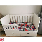 LargeWoodenCotwithSplitDrawerWhite with Spider-Man themed bedding against a plain wall.