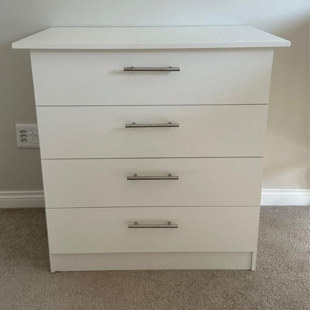 White dresser with four drawers in a room setting