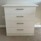 White dresser with four drawers in a room setting
