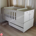 BabyBedroominaBox5-in-1Cot White baby crib with drawers in a room with curtains
