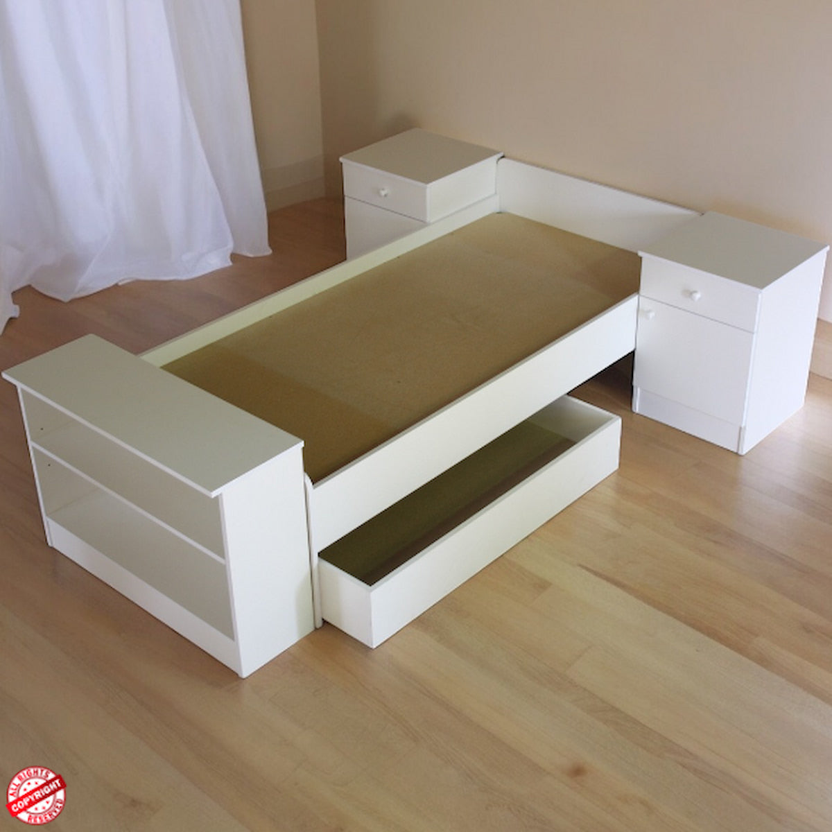 BabyBedroominaBox5-in-1Co turned into White L-shaped bed with storage drawers on a wooden floor.