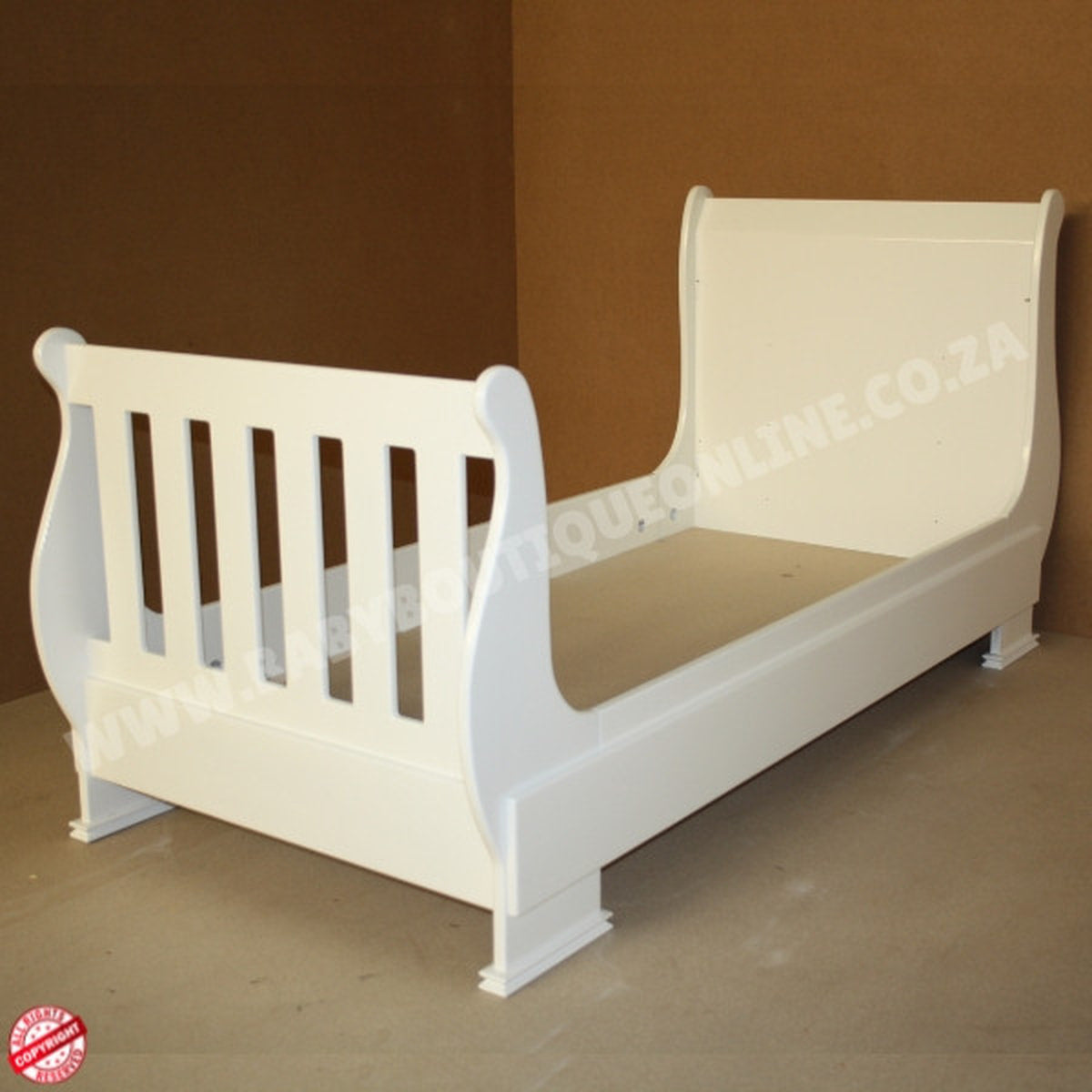 SleighCot-ConvertsintoSingleBed against a brown wall