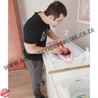 Man holding a baby in a changing table with 'Boutique Online' branding.