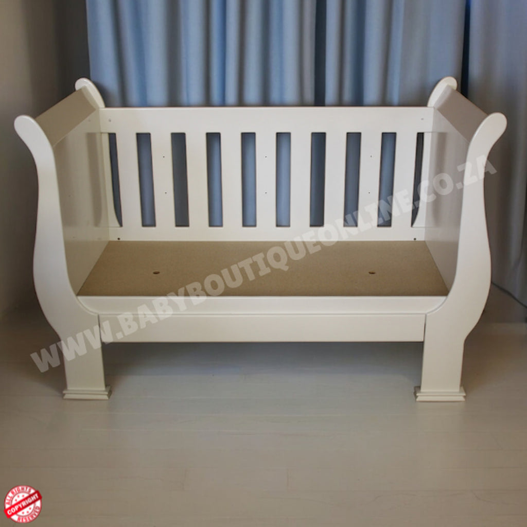 2in1 Sleigh Cot White baby crib with a beige mattress against a gray curtain background