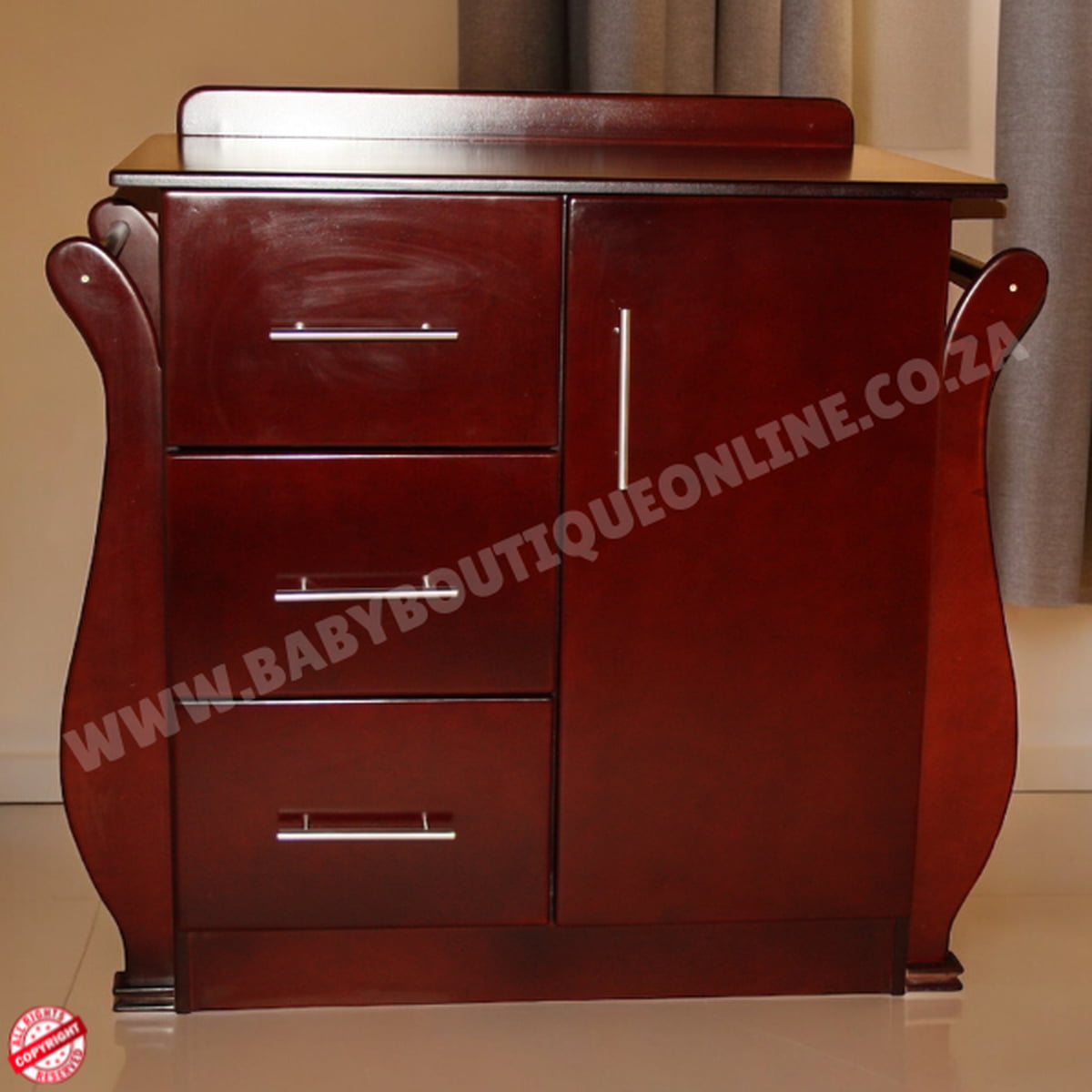 Wooden dresser with three drawers on a beige floor and wall.