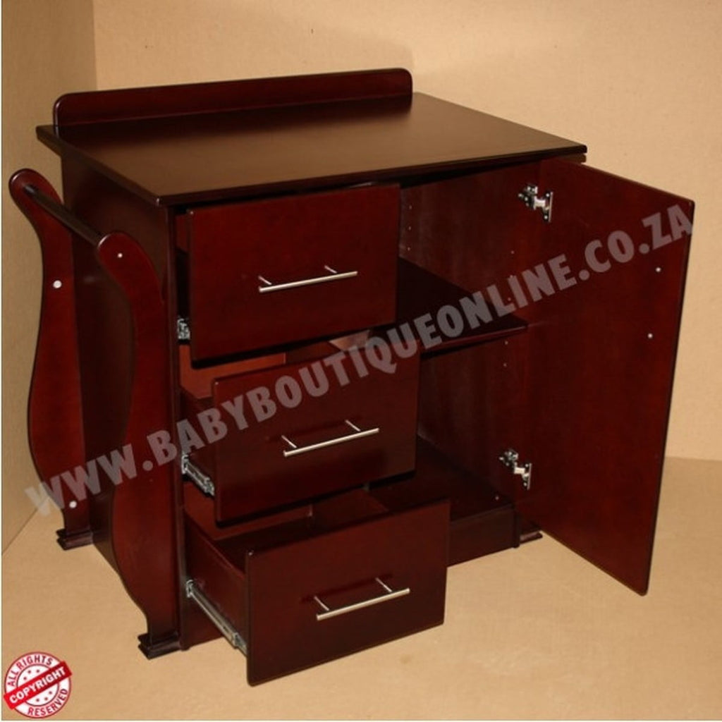 Wooden cabinet with drawers and a door on a beige background, featuring the website www.babyboutiqueonline.co.za.