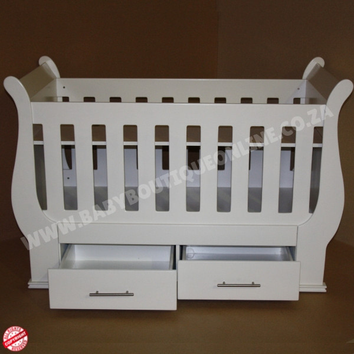 Sleigh Cot with Drawers with pink bedding in a room with a decorative wall sticker.