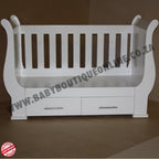Sleigh Cot with Drawers with pink bedding in a room with a decorative wall sticker.