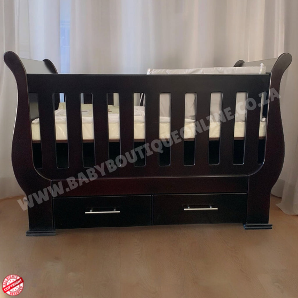 SleighCot with Drawers Burgundy with drawers against a white curtain background