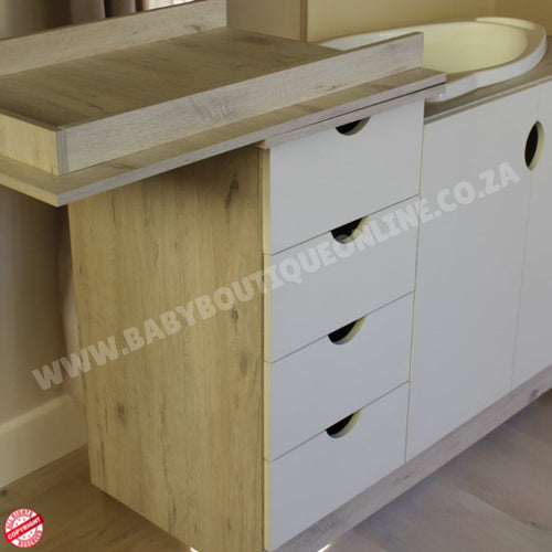 Bathroom vanity with wooden top and white drawers, featuring a watermark.