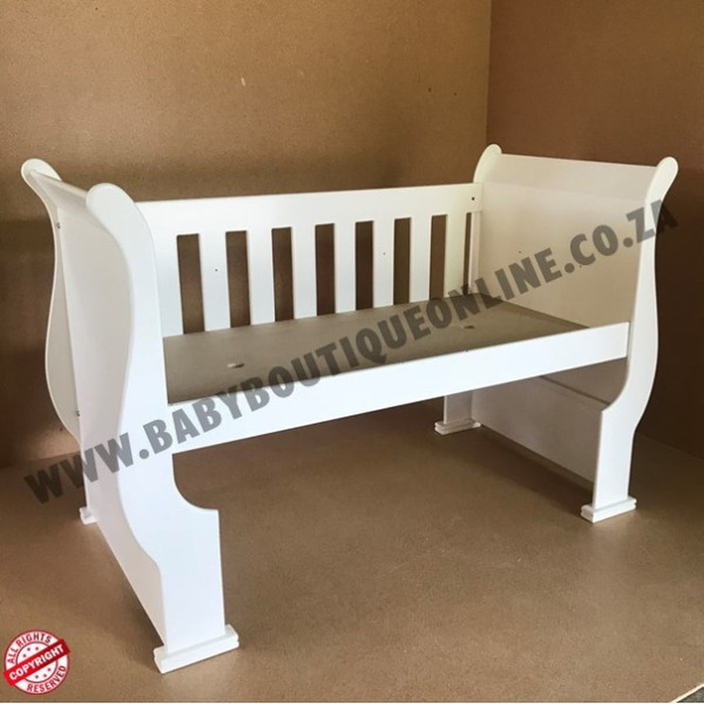 3-in-1 Sleigh Cot and Co-Sleeper White baby crib on a wooden floor with white curtains in the background White baby crib with 'www.babyboutiqueonline.co.za' branding on a brown background
