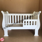 3-in-1 Sleigh Cot and Co-Sleeper White baby crib on a wooden floor with white curtains in the background 