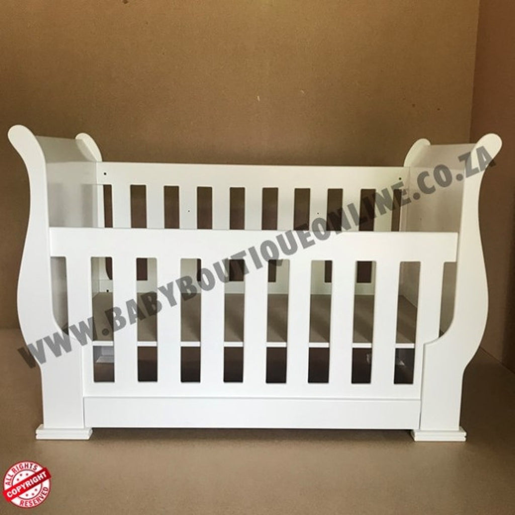3-in-1 Sleigh Cot and Co-Sleeper White baby crib on a wooden floor with white curtains in the background