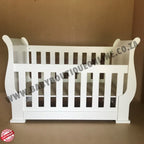3-in-1 Sleigh Cot and Co-Sleeper White baby crib on a wooden floor with white curtains in the background