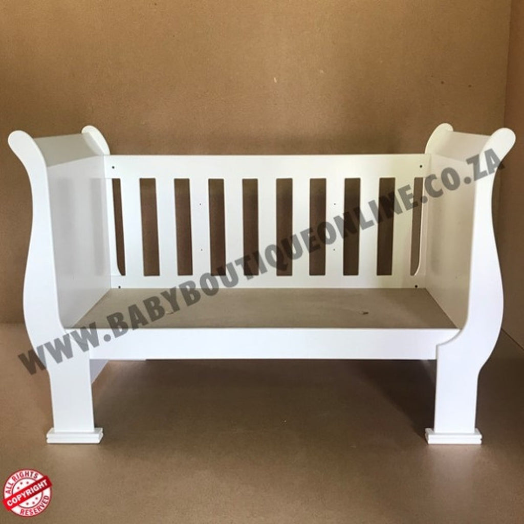3-in-1 Sleigh Cot and Co-Sleeper White baby crib on a wooden floor with white curtains in the background