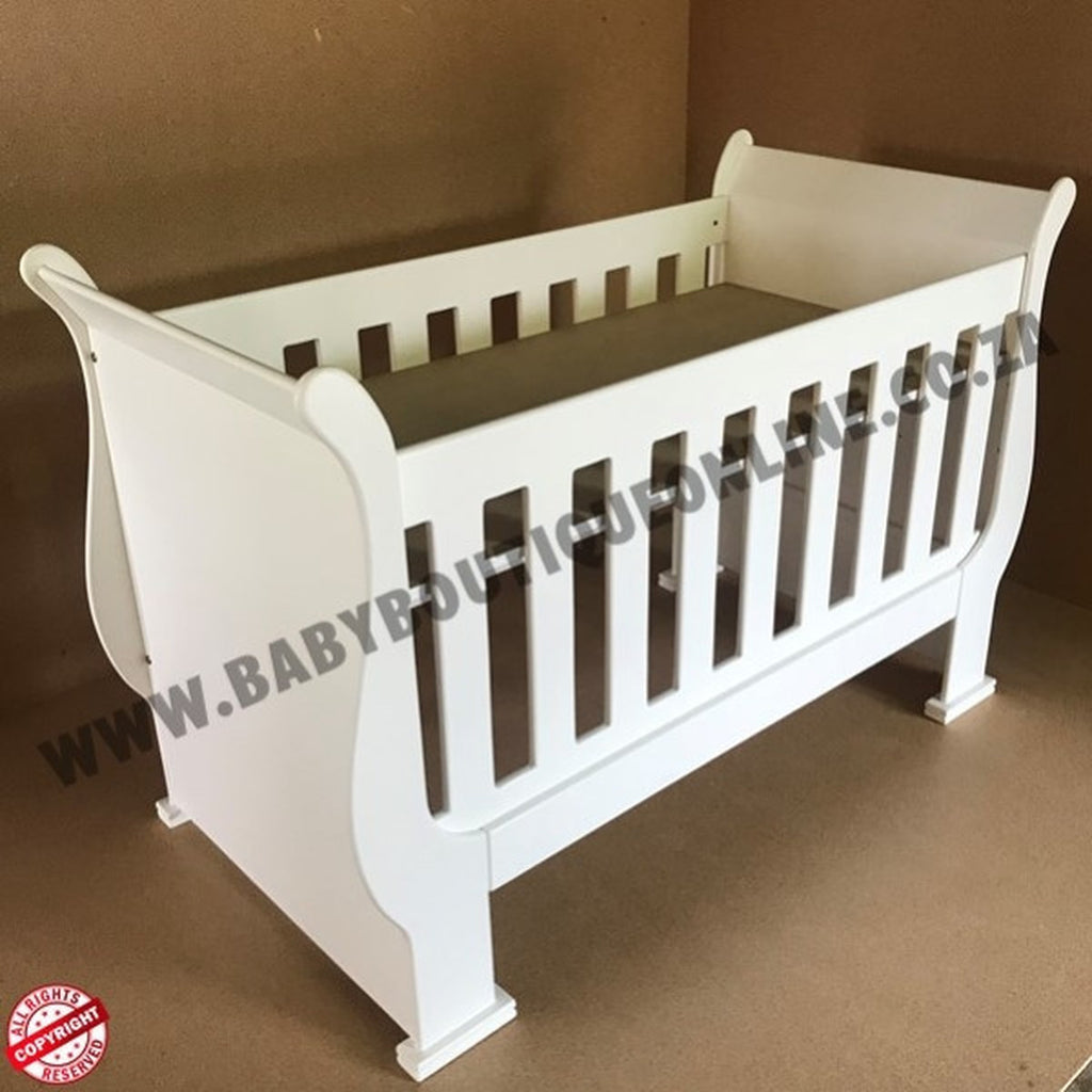 3-in-1 Sleigh Cot and Co-Sleeper White baby crib on a wooden floor with white curtains in the background