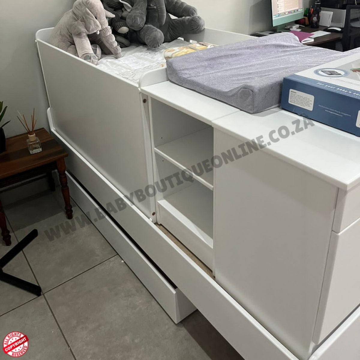 White storage unit with shelves and a drawer in a room setting.