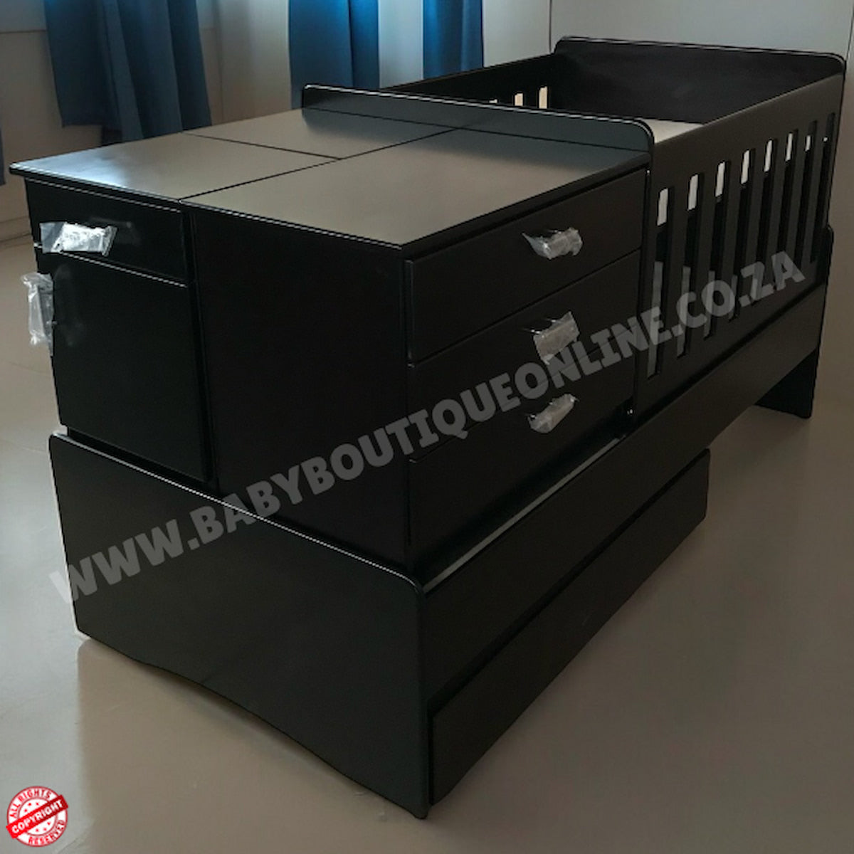 BabyBedroominaBox5in1Cot- crib with drawers and a mattress on a plain floor.
