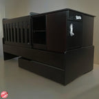 BabyBedroominaBox5in1Cot- with a white wall background