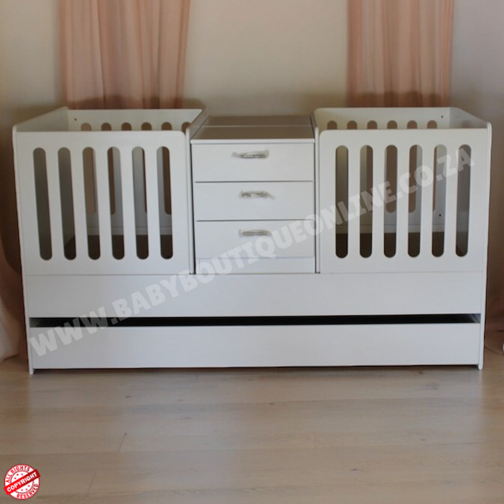 BabyBoutiqueTwinCot in a baby room with wooden floors