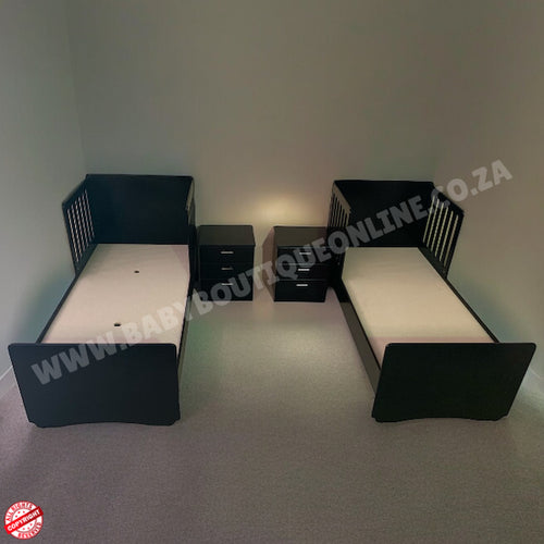 Twin beds with nightstands in a minimalistic room.