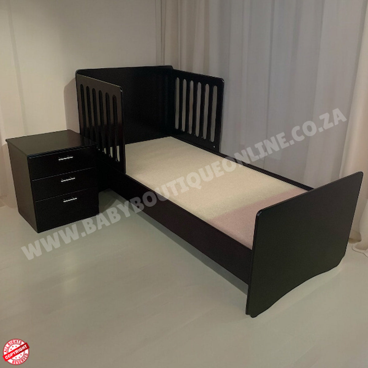 Burgendy bed with a nightstand against a white curtain background