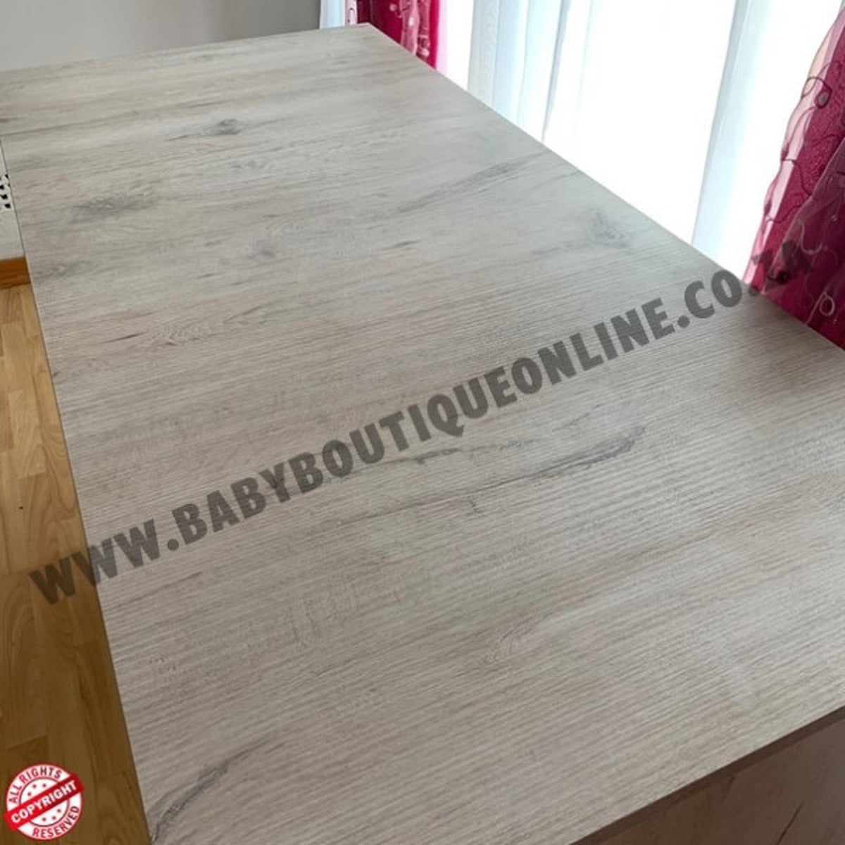 Wooden surface with 'www.babyboutiqueonline.com' branding.