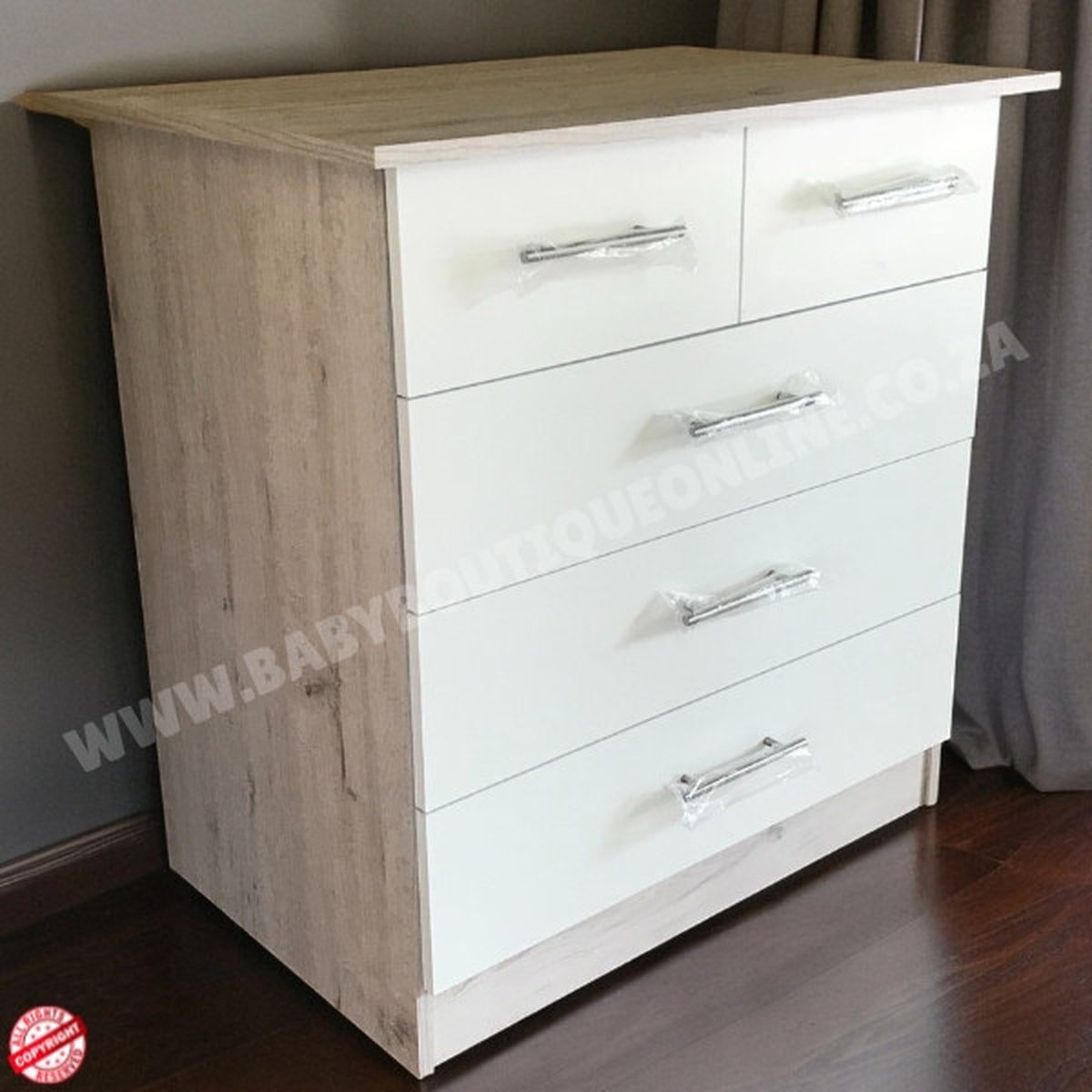 Two-toned dresser with white and wood finish on a wooden floor.