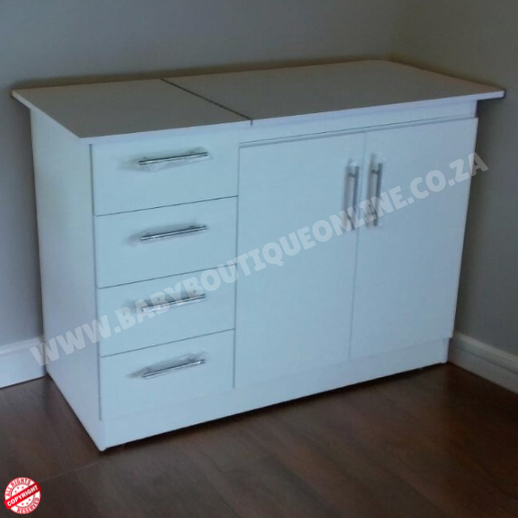 White cabinet with drawers and a door on a wooden floor against a plain wall.