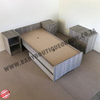 BabyBedroominabox5-in-1CotWooden children's bed with storage drawers on a plain floor.