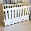 WoodenCotwithDrawerSupawoodMDF with drawers on a wooden floor against a gray curtain background