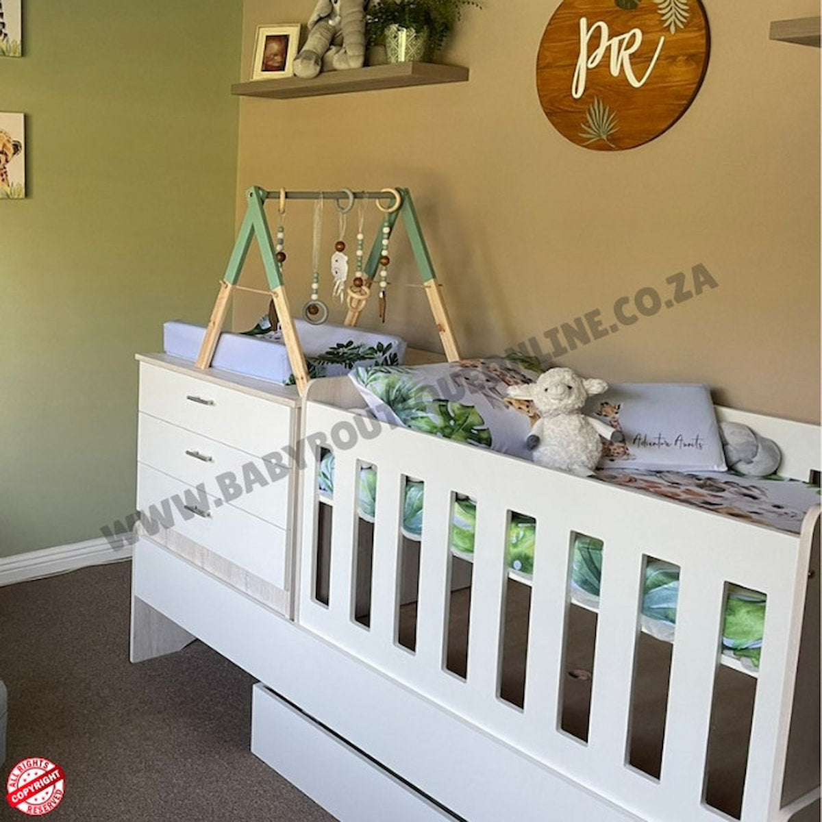 White crib with wooden arch and baby items in a nursery setting