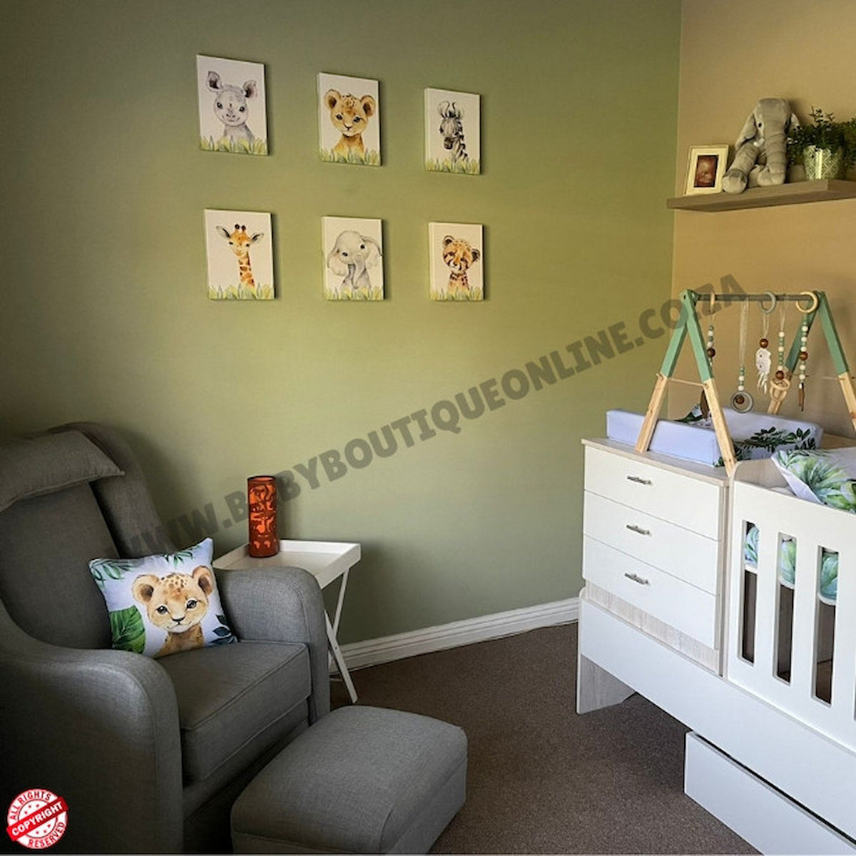 Nursery room with green walls, baby furniture, and decorative elements.