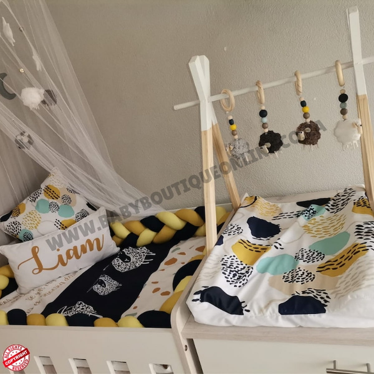 Nursery setup with crib, decorative pillows, and baby mobile.
