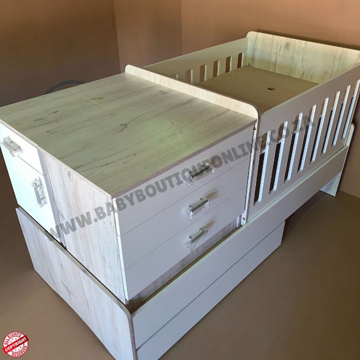 Wooden crib with drawers and a mattress on a plain background