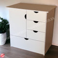 White dresser with four drawers against a neutral wall.