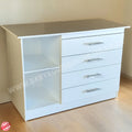 White dresser with multiple drawers and a glass panel on a wooden floor.