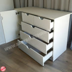 White dresser with multiple drawers on a wooden floor.