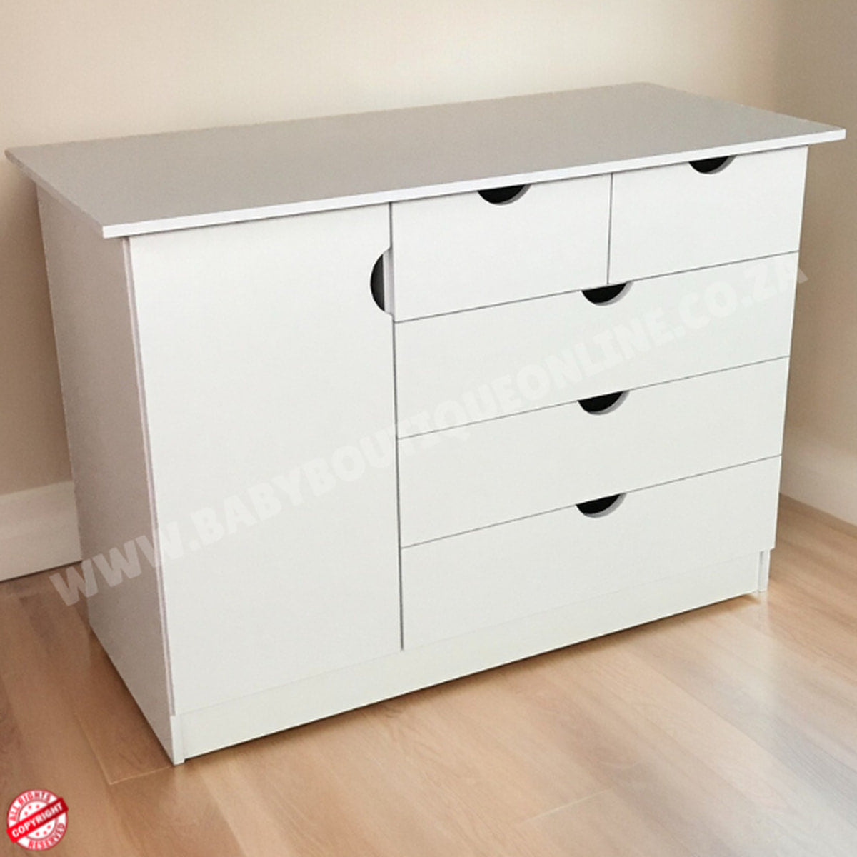 White dresser with multiple drawers on a wooden floor.
