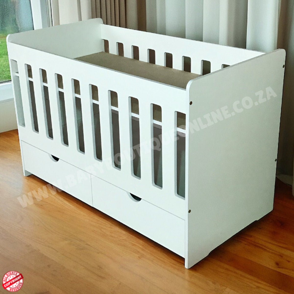 Large Wooden Cot with split Drawer-HalfMoon Cut Outs White crib with gray mattress on a wooden floor, brand logo visible