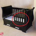 Black baby crib with a red circle highlighting a small defect on the side.
